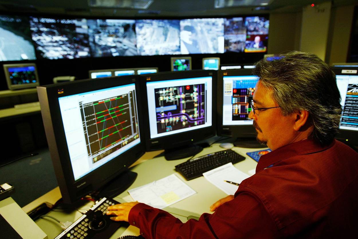 Man supervising monitors in a control room